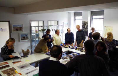 Researchers compare and discuss ceramic samples in the lab.jpg